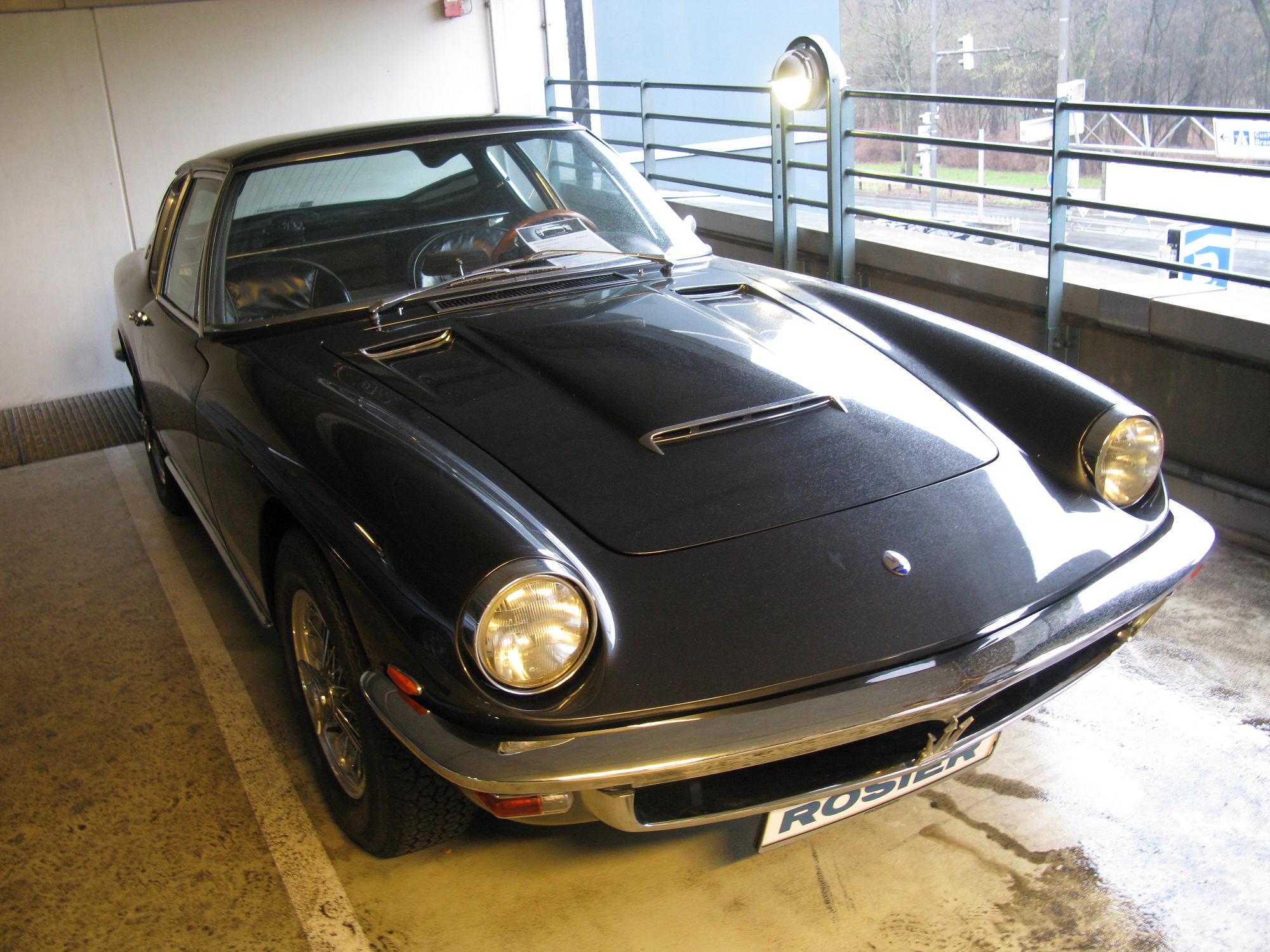 a black ferrari parked in front of a window