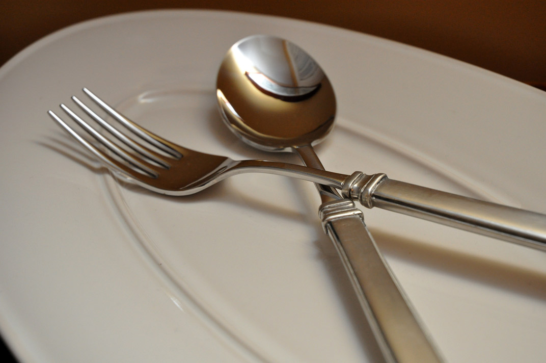 a set of silverware is sitting on a plate