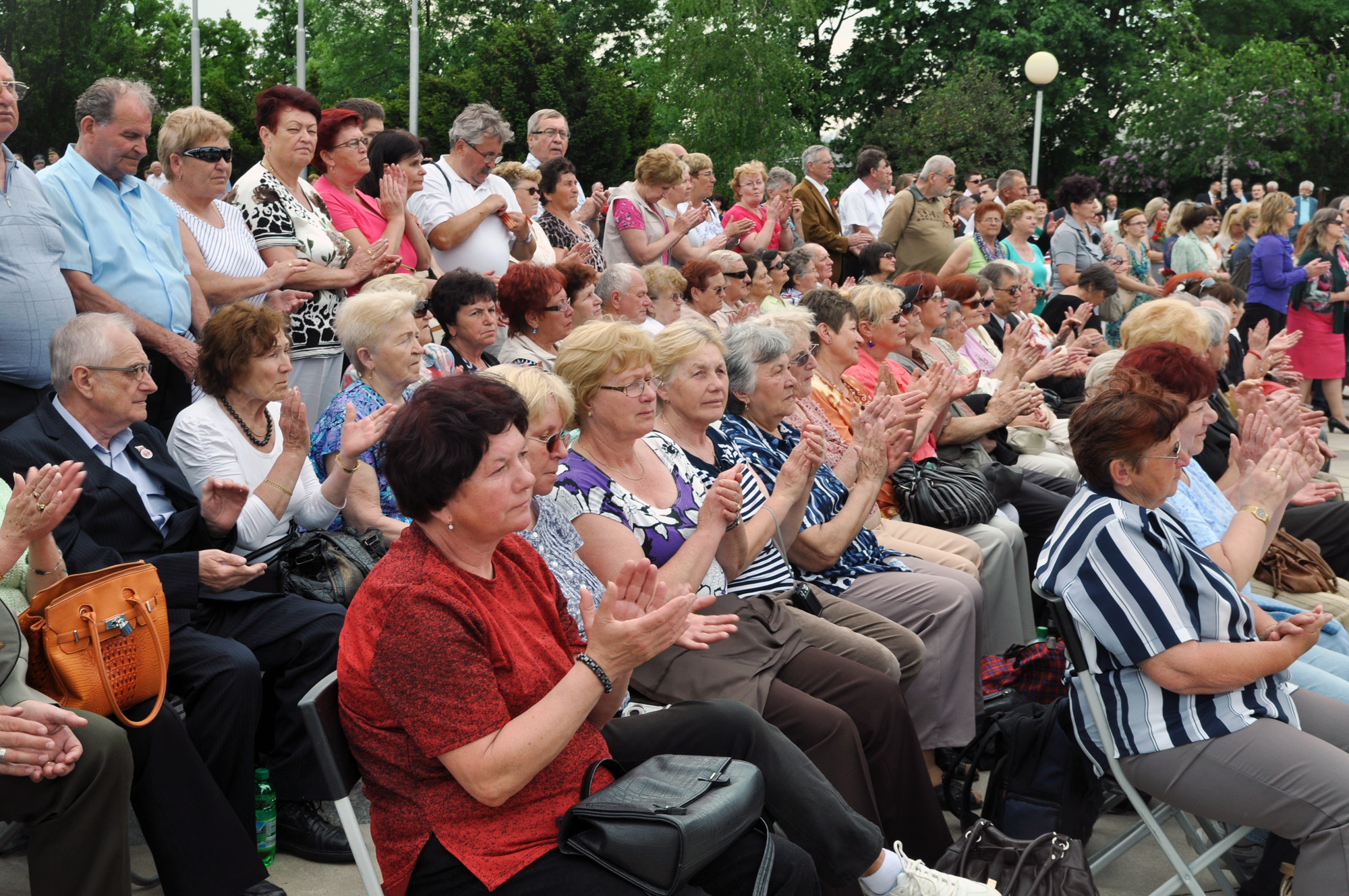 a group of people are sitting in front of an audience