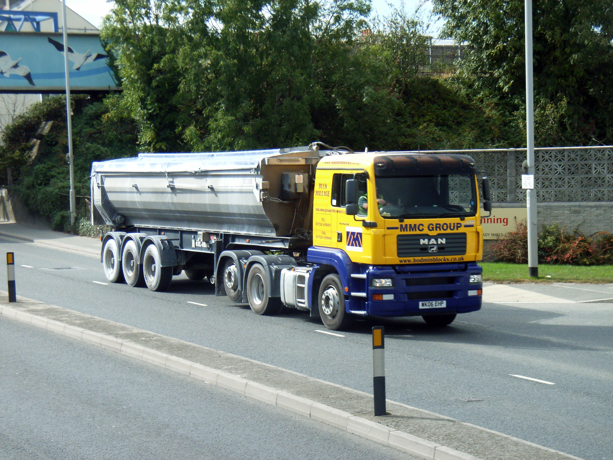 large transport truck with two tankers attached to it's back