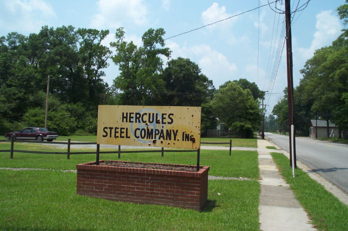 a sign for a steel company in a residential neighborhood