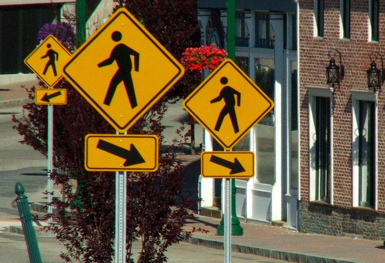 street signs displayed on poles next to buildings