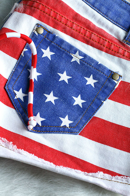 a pair of american flag printed shorts with a straw in the pocket