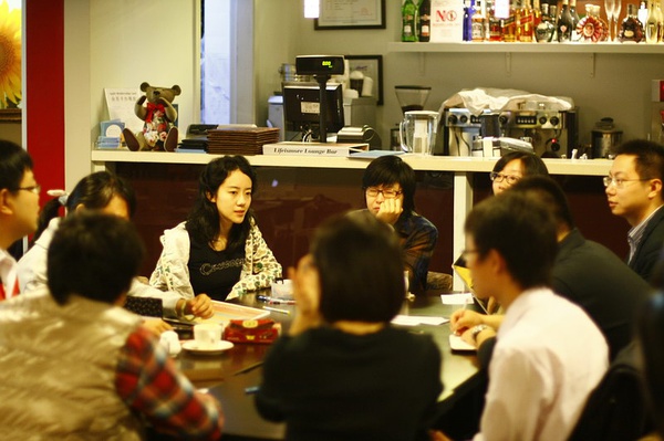 people sitting at a restaurant eating and drinking drinks
