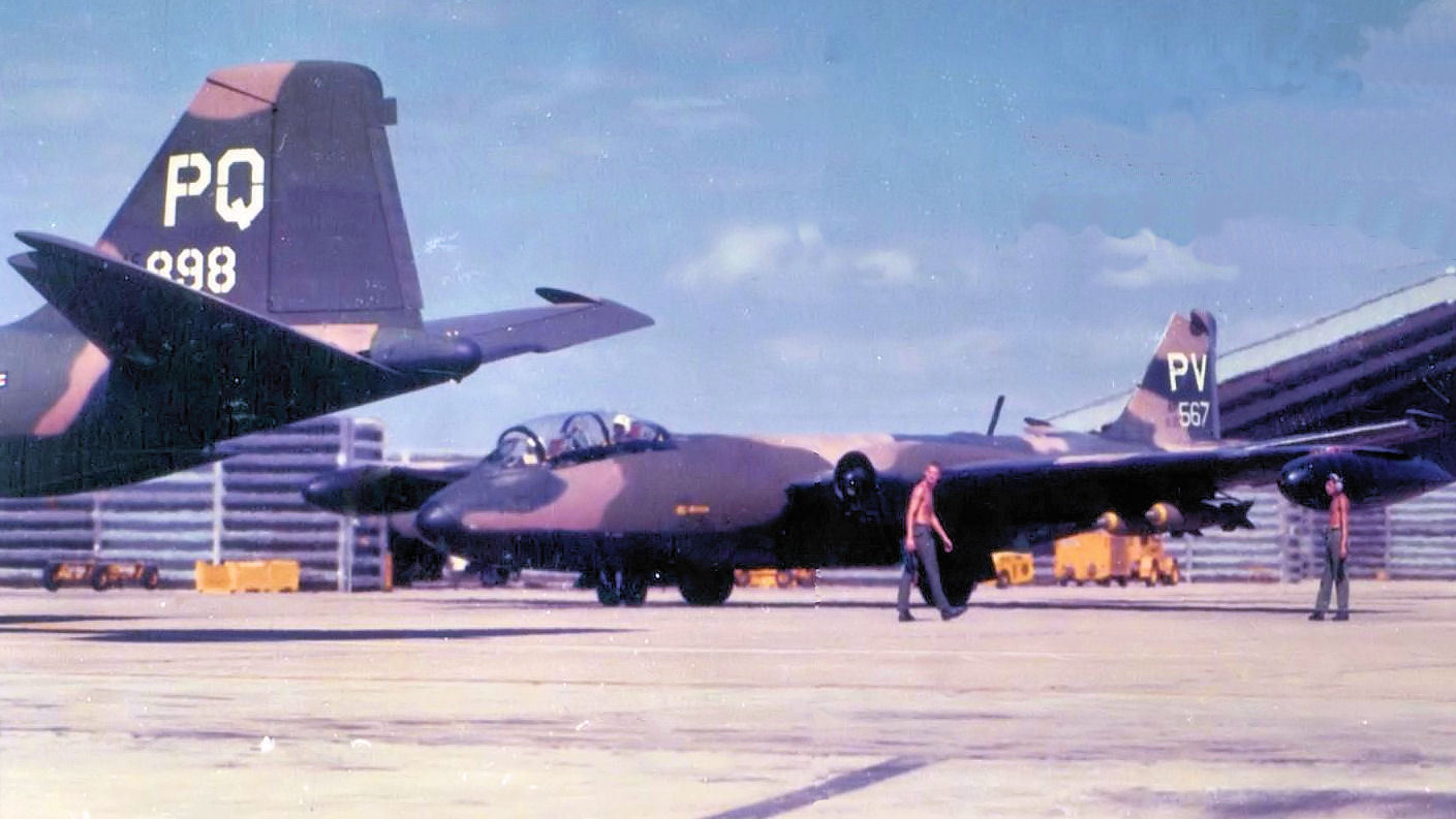 an old military jet being displayed in a hangar