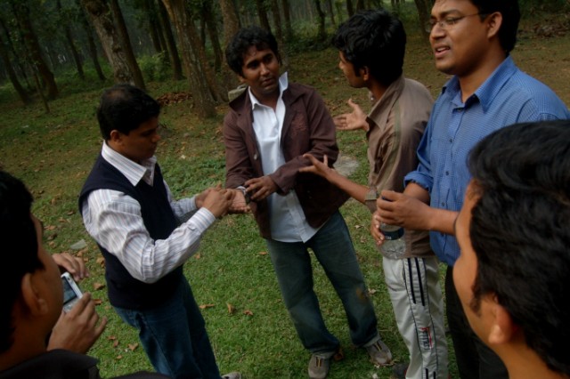 a group of men in the woods playing a game