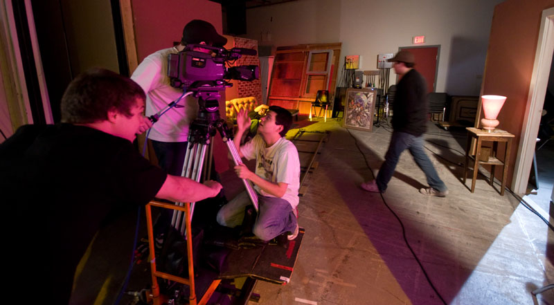 two men and one woman, all behind a camera set