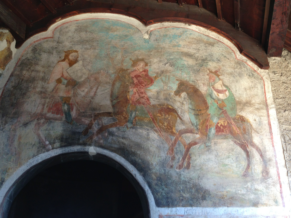 a painting of people on horses near a tunnel