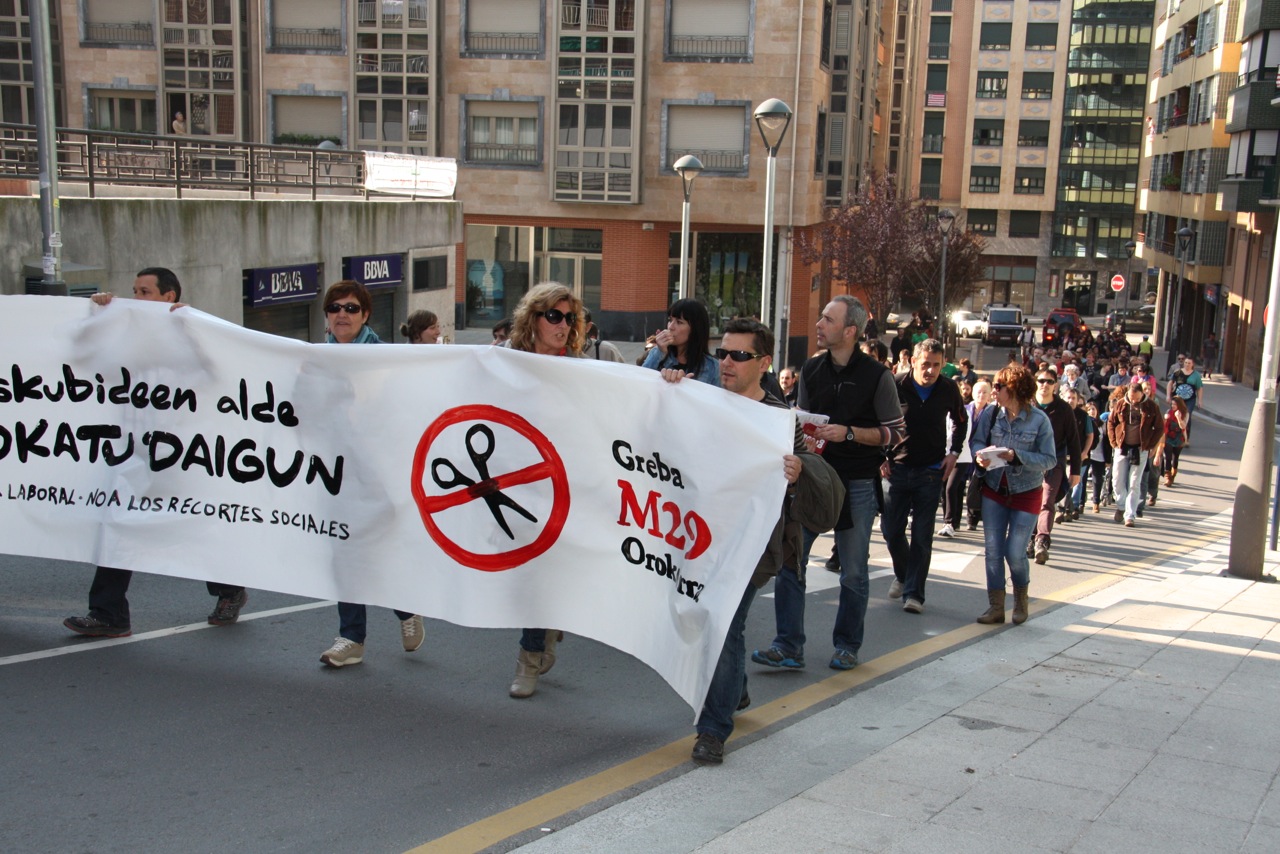 a number of people holding protest signs in front of a building