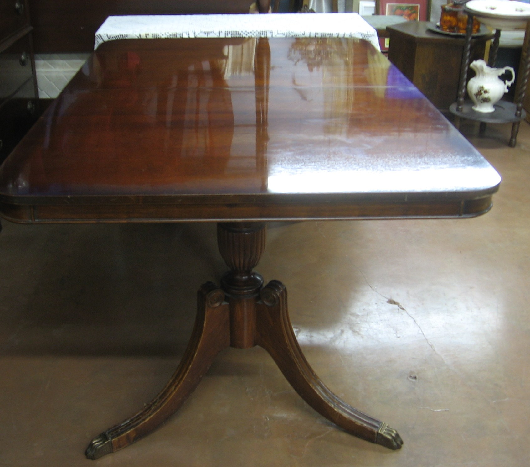 there is an old dining table sitting in the store