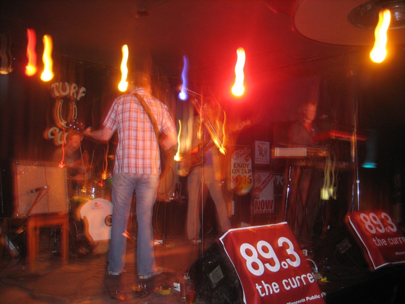 people are standing around in a room with light shining from behind