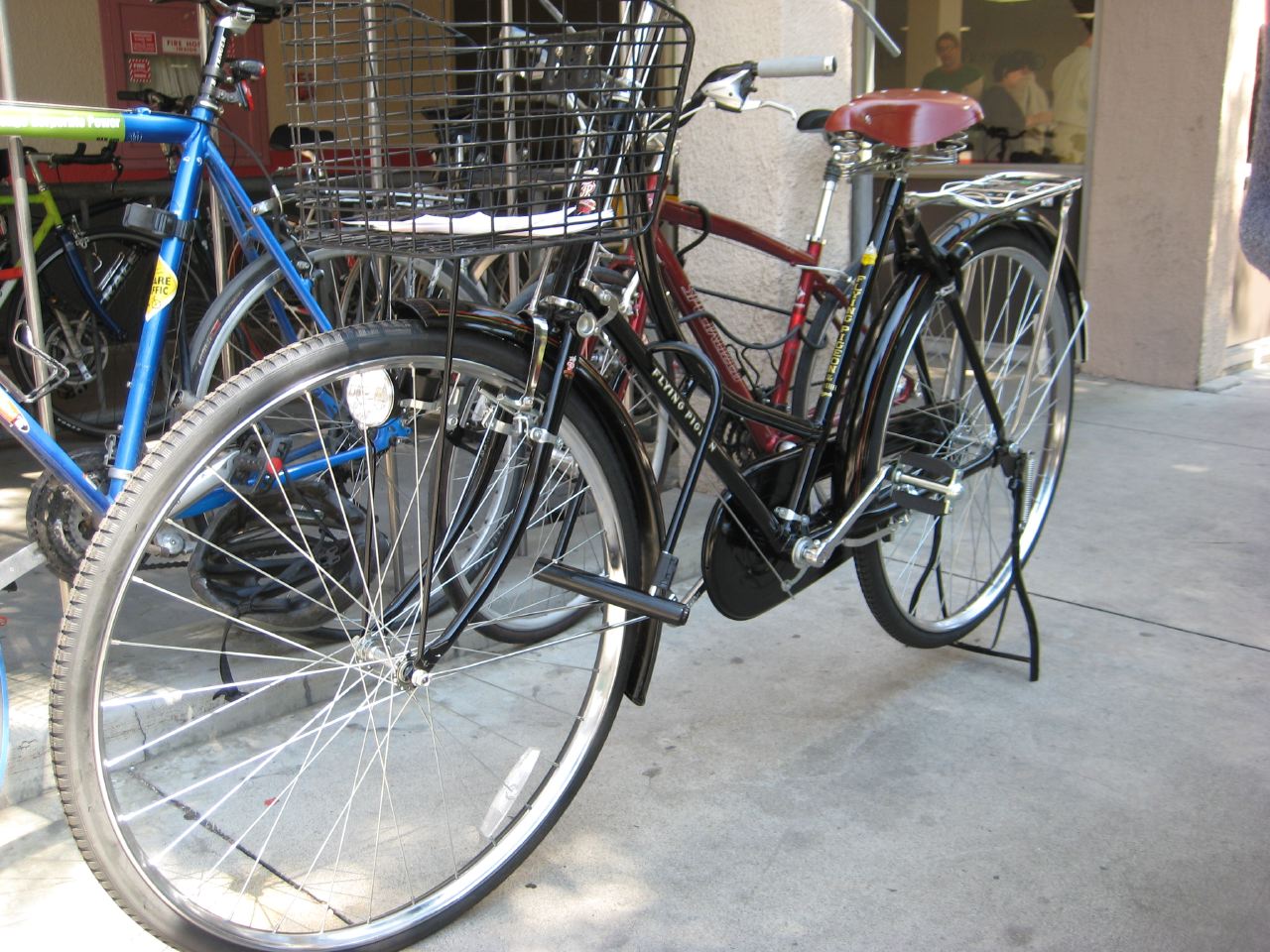 two bicycles are parked in front of the store