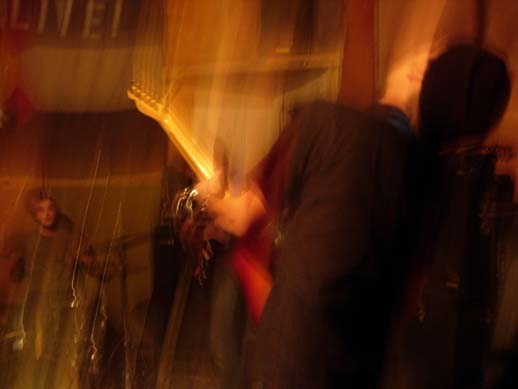 some blurry pos of people playing guitars