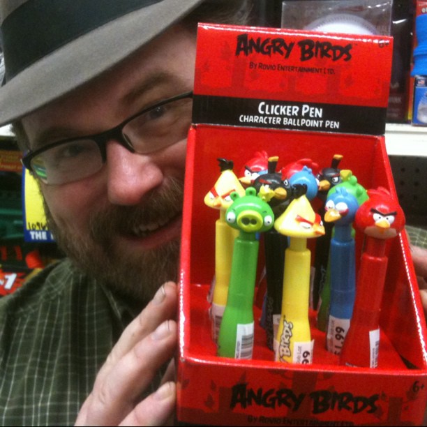 a man holding a display box full of angry birds