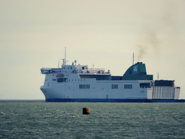 the large ferry boat is floating on the water