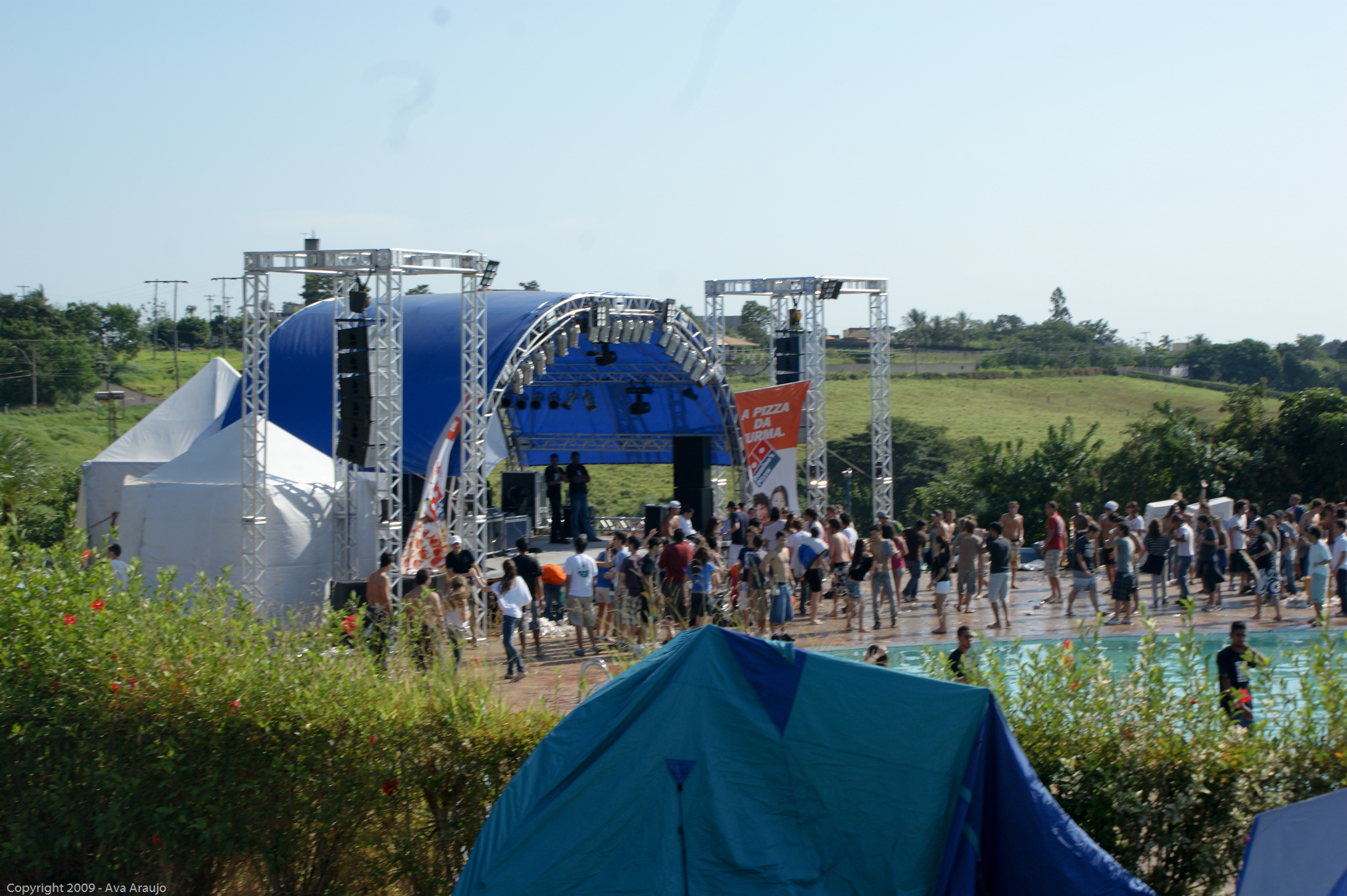 some people standing in a group around a blue and white stage
