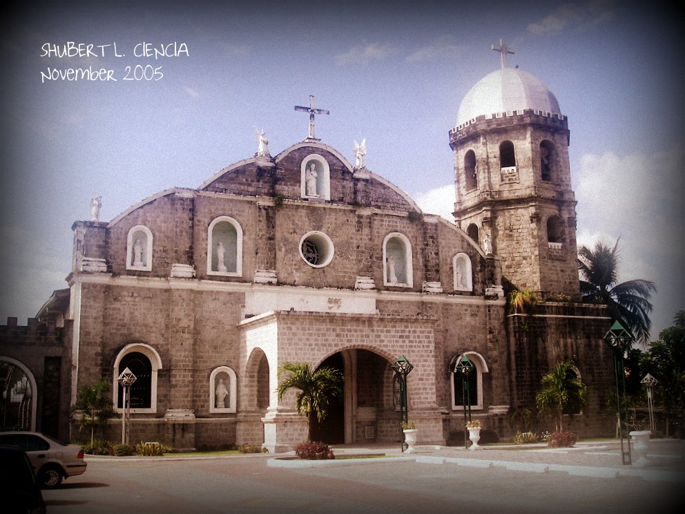 a very old building with two towers and a cross on the top