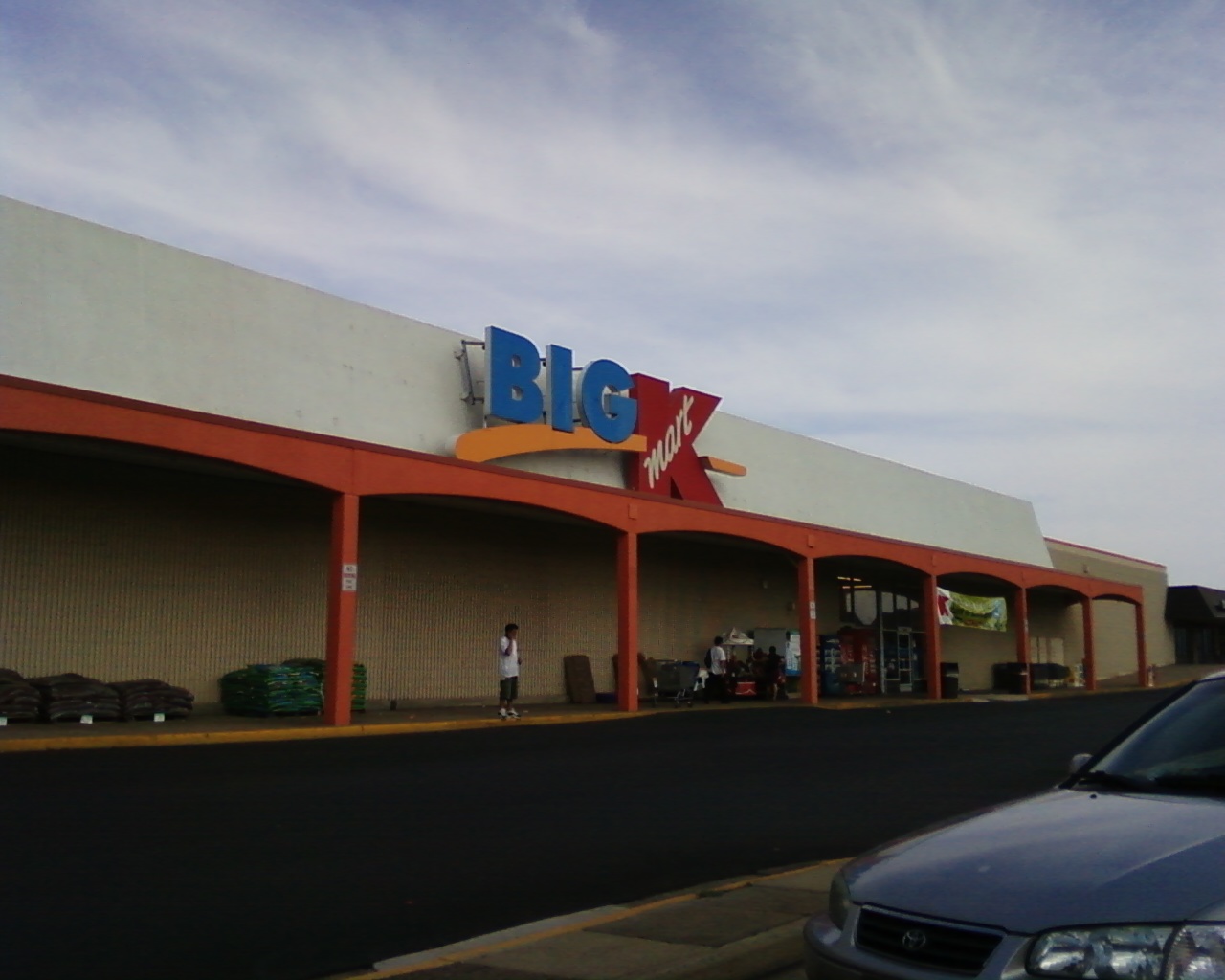 the front of a store with people walking outside it