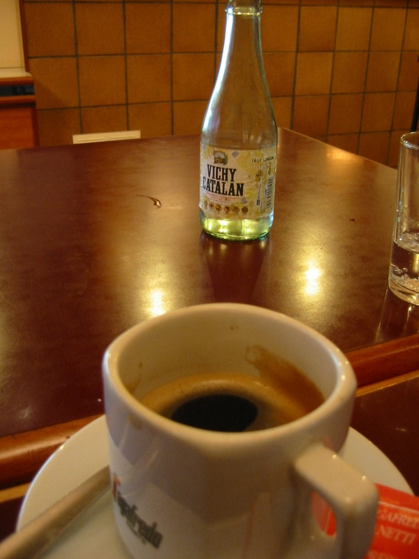 a water cup and two drinking glasses on a counter