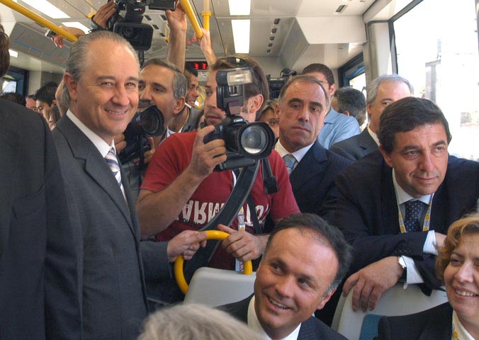several men with cameras on a city bus