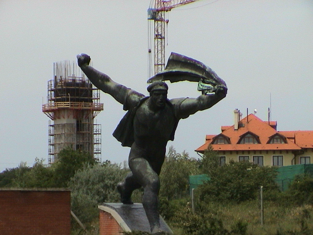 there is a statue of a man that is holding a drink