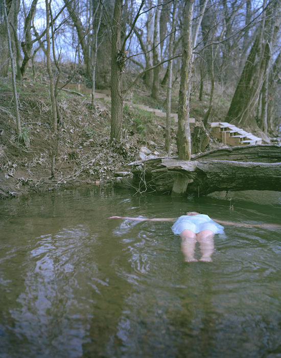 a person is lying on their stomach in the water