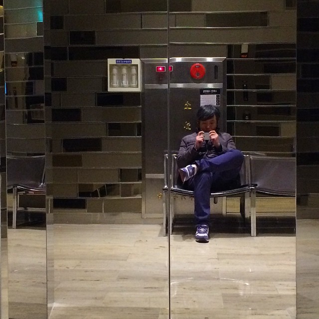 a reflection of a person sitting in a chair