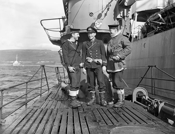 three men standing on a boat dock posing for a picture