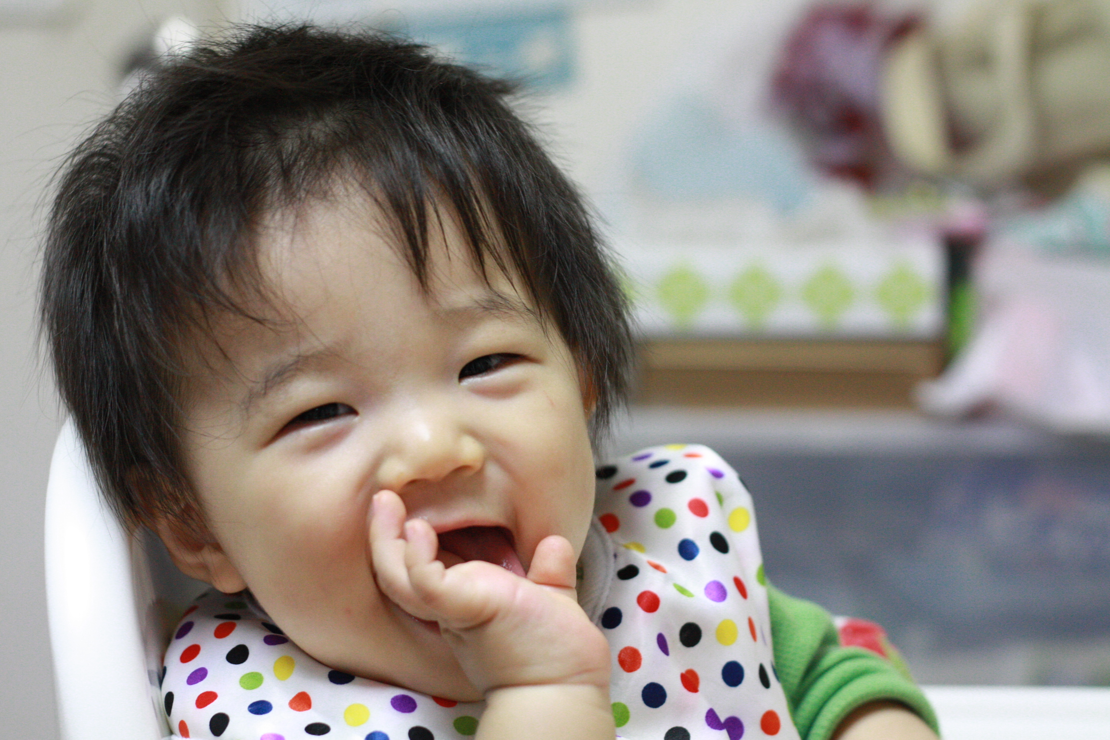 baby looking up at the camera with teeth