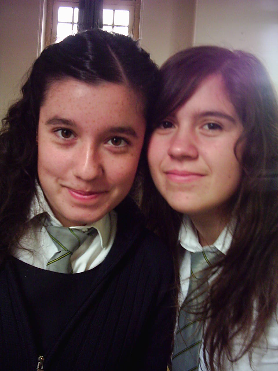 two pretty young women standing next to each other