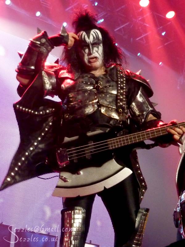 kiss perform on stage with a guitar in hand