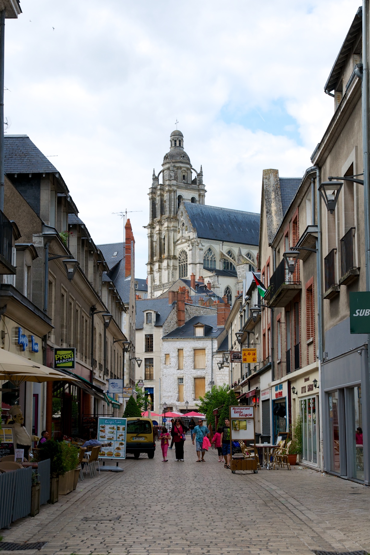 a city street with some people walking around