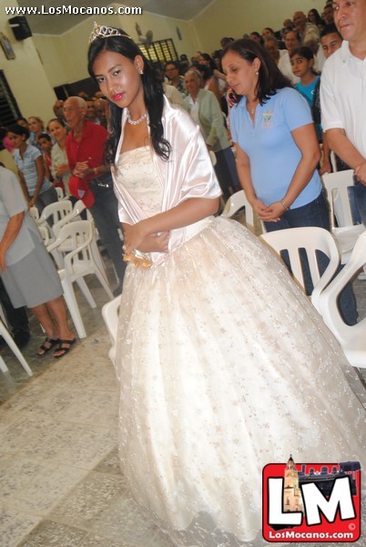 a woman in a wedding dress walking down the aisle