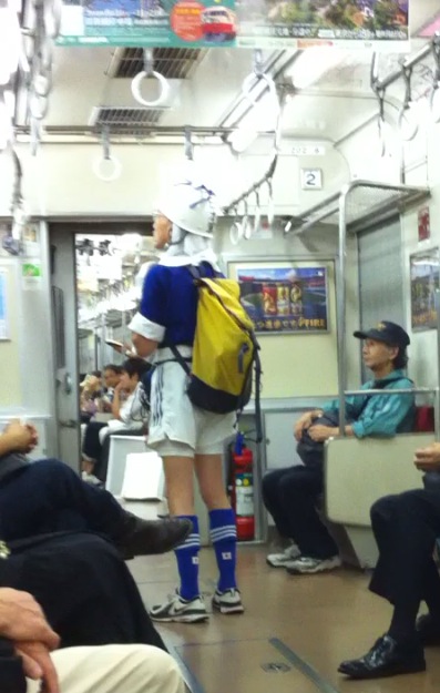 there are many people seated on a train with bags