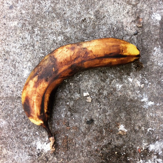 a close up of a banana on concrete