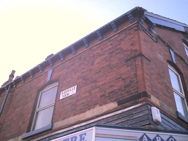 an old building with a few signs posted on it