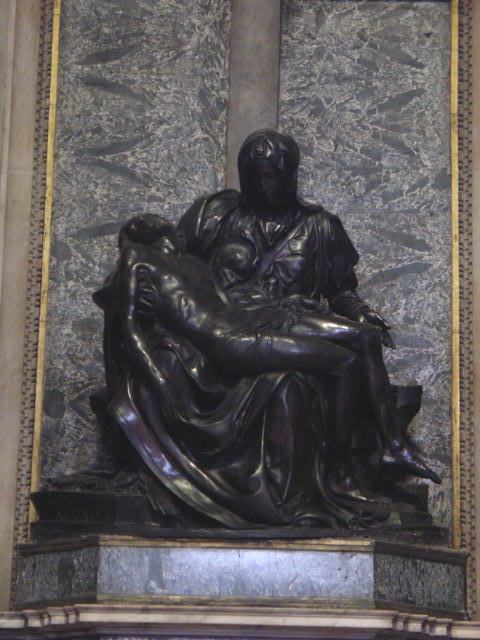 the statue of person holding his child