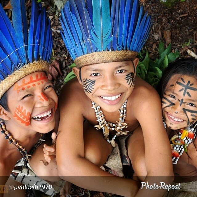 two girls wearing native indian headgear smiling
