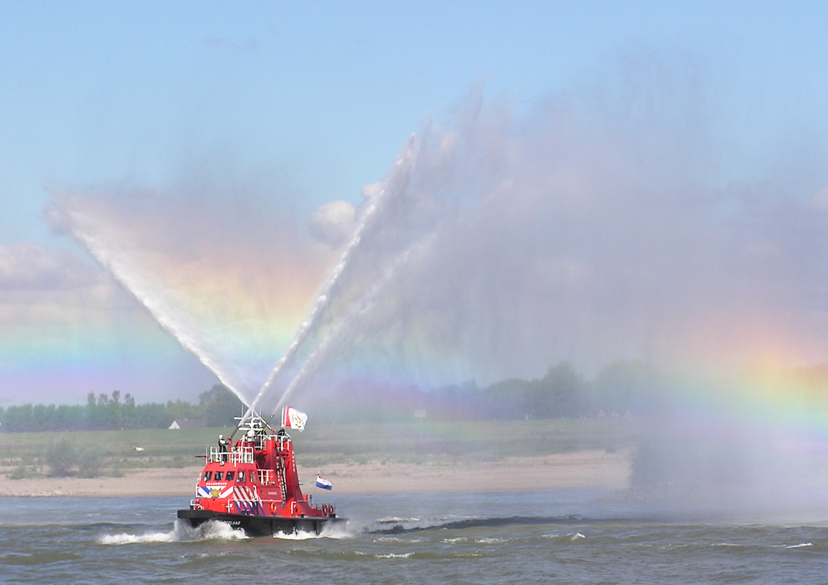 a fireboat sprays water in the air above a body of water