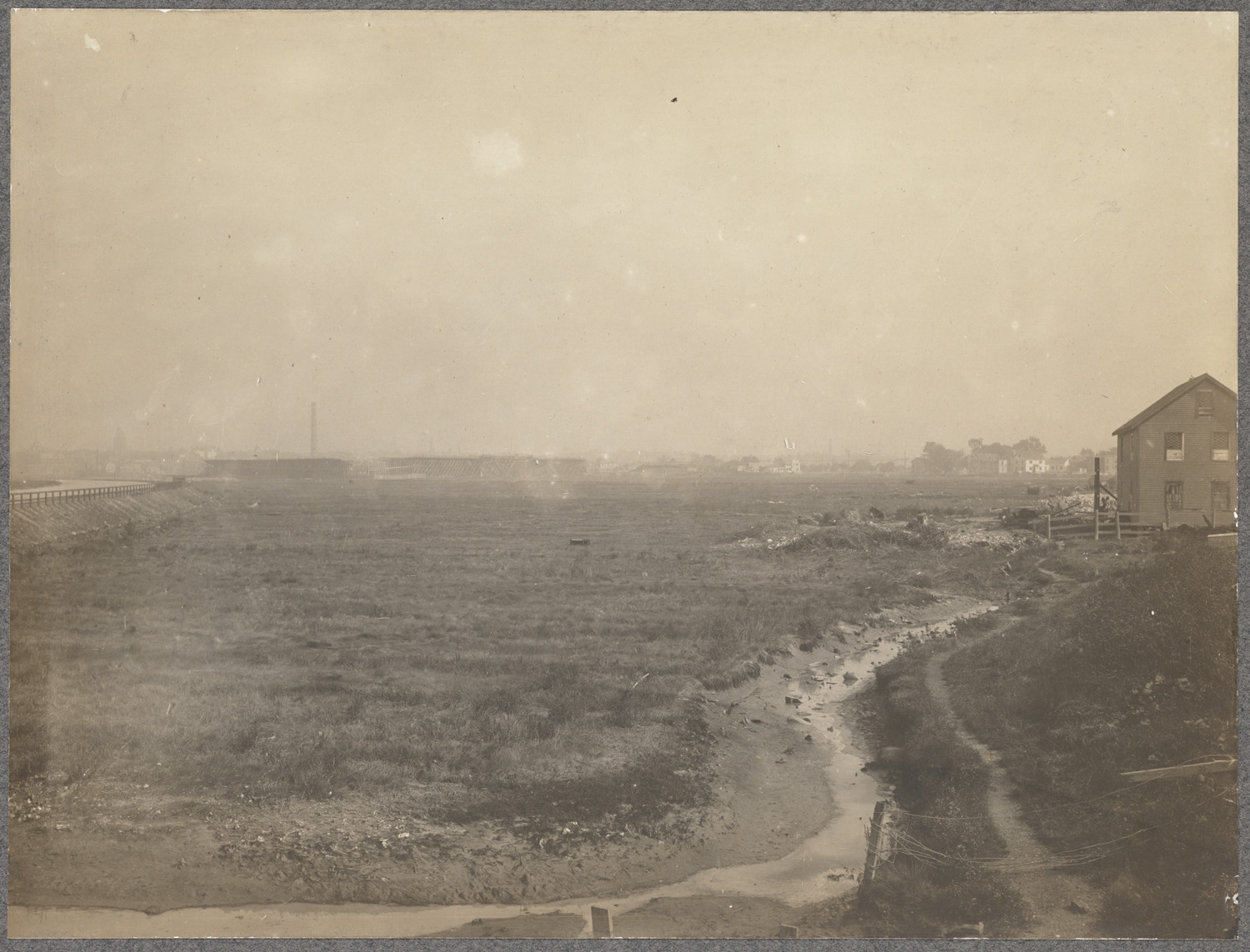 a old picture of a large marsh on a cloudy day