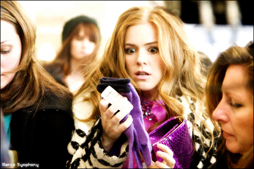 a woman in a crowd checking her cell phone