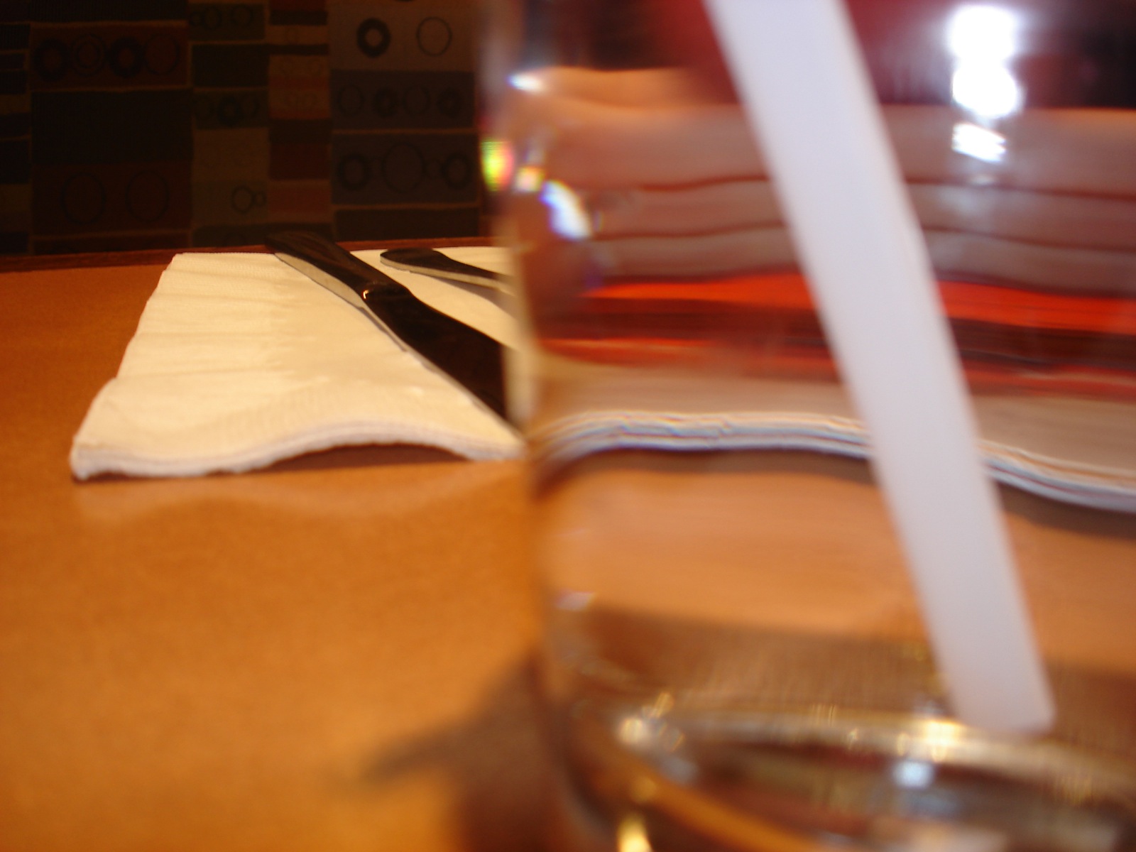 a glass with some black and white napkin on it