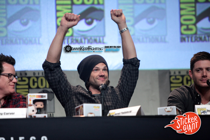 three men at a comic convention one man raising his arms