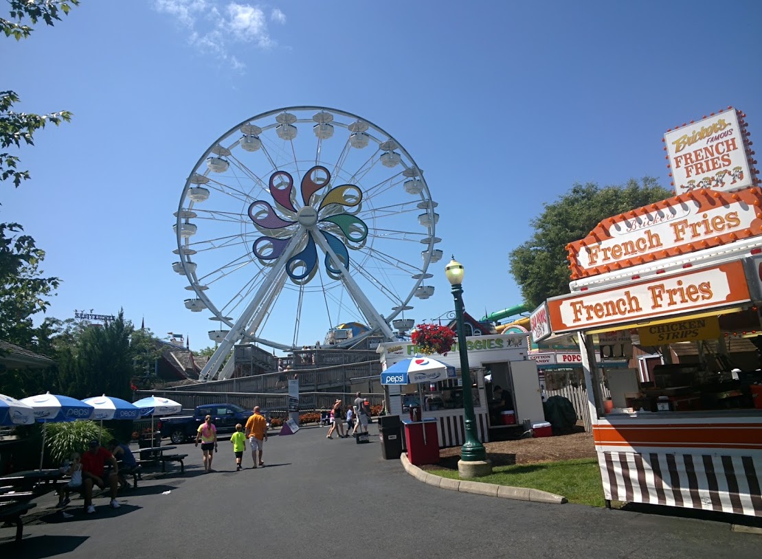 the fair goers are lined up on the road