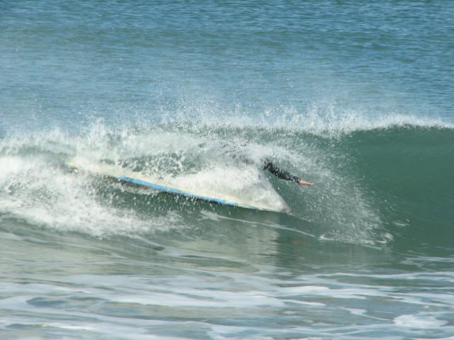 a person riding a surfboard on a wave