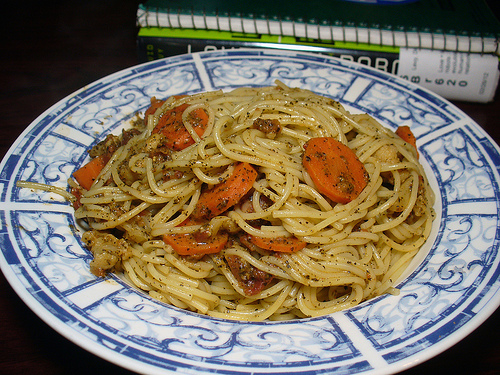 the plate contains some pasta and carrots