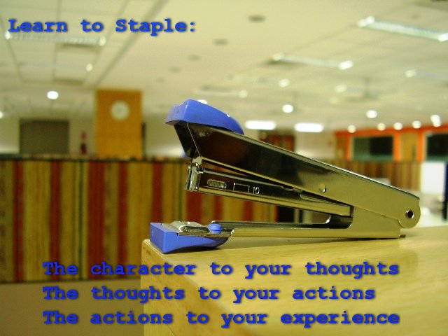 a blue stapler with some writing underneath it