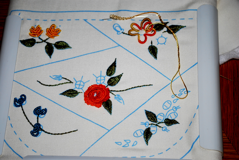 the square stitch is decorated with embroidery on fabric