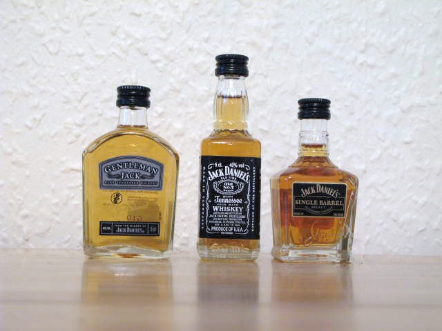 three bottles of liquor, each one with its own unique label