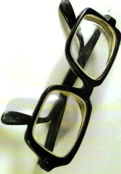 an eyeglass is displayed on a white surface